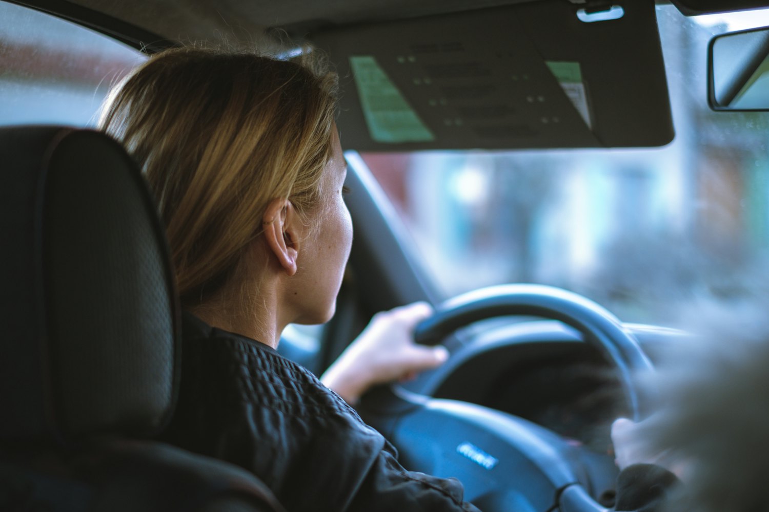 A young driver at the wheel in daylight, framed as a video thumbnail