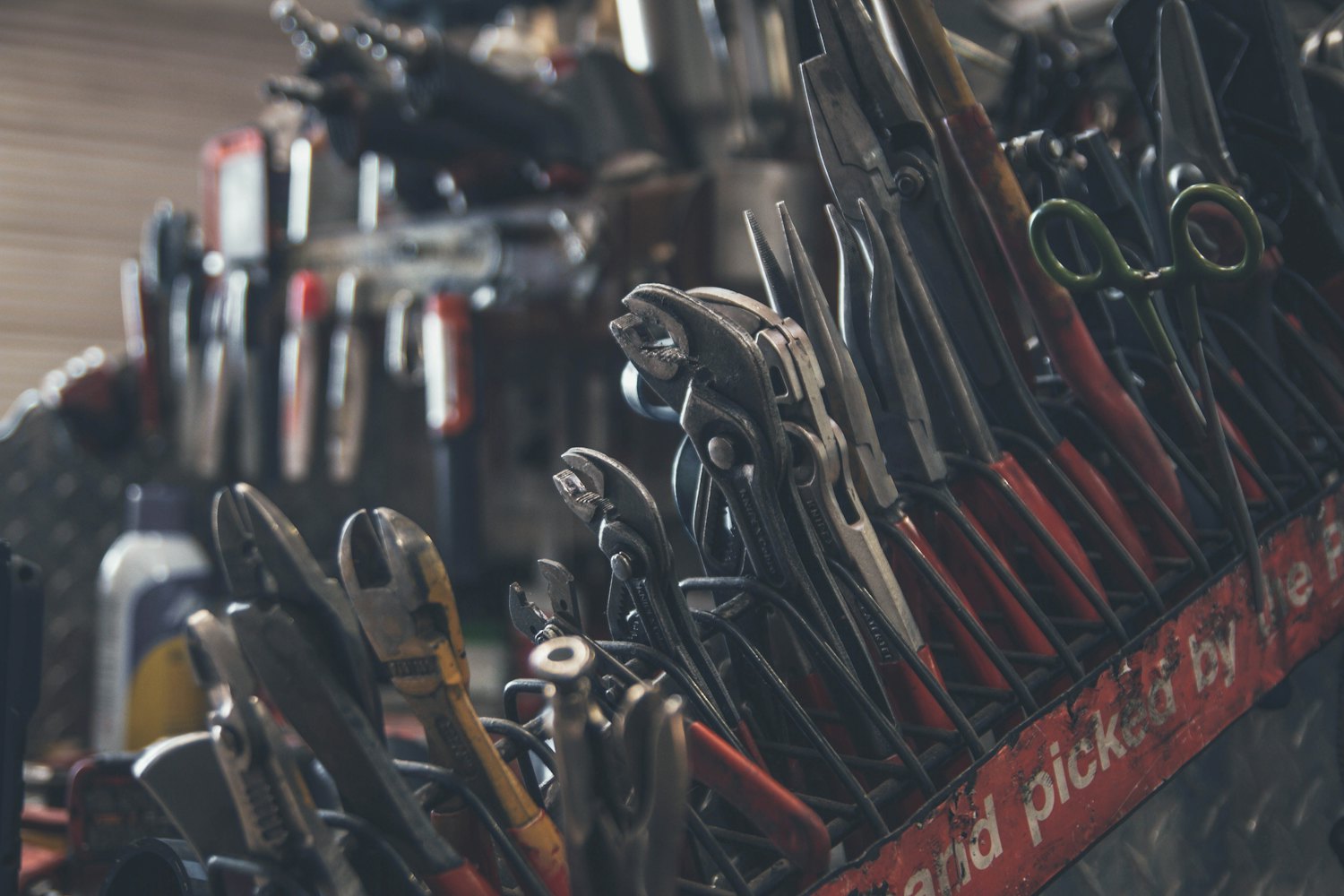 A tray of well-used hand tools, the kind kept in a working van
