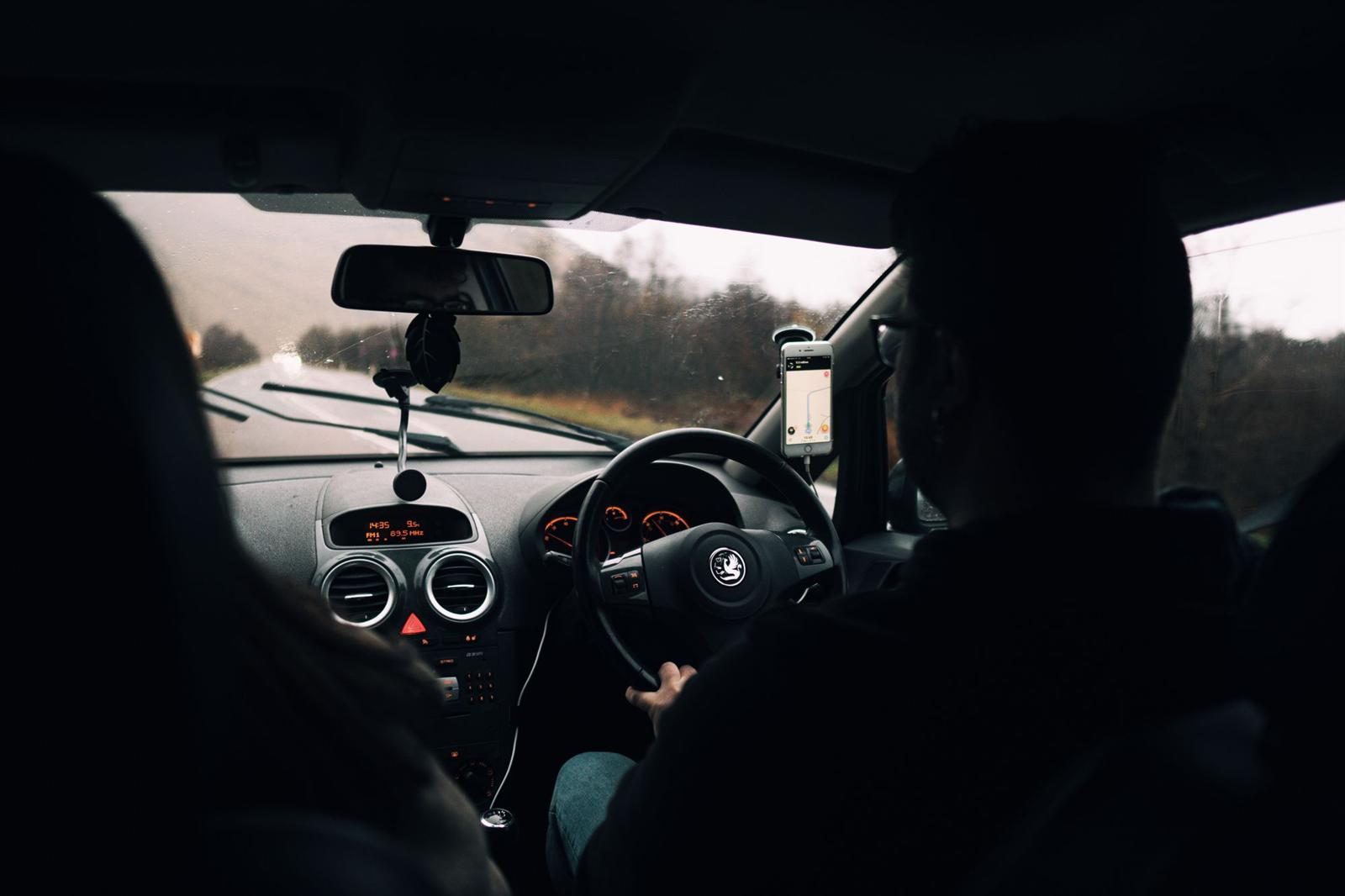 A young driver at the wheel on a rainy drive home